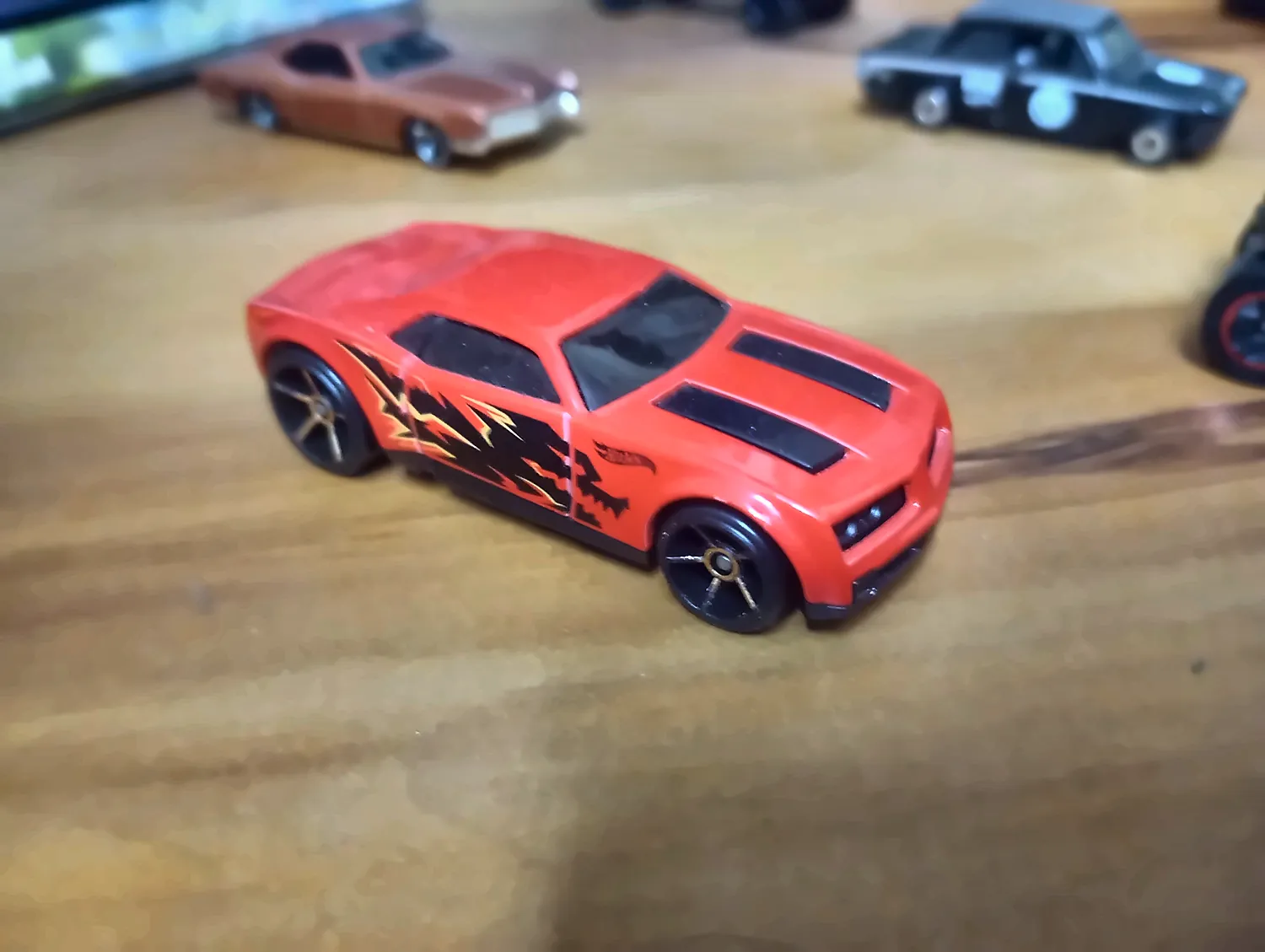 a red Hot Wheels Camaro