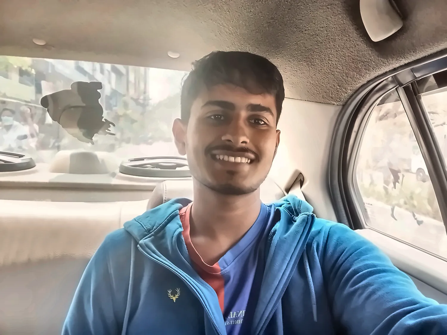 me smiling in the car