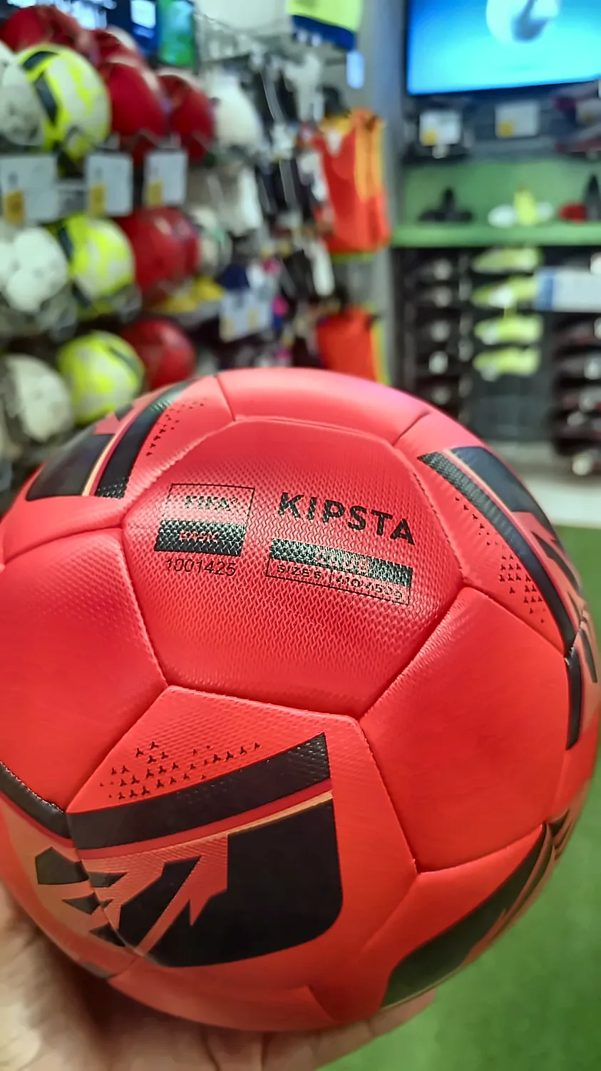 a red Kipsta football