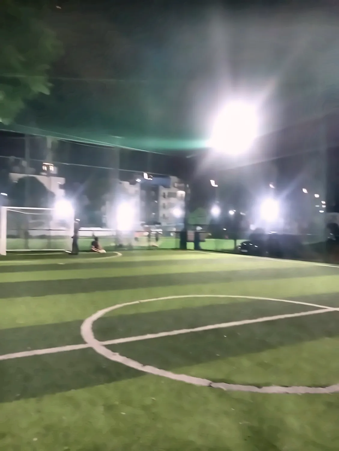 a turf under floodlights at night