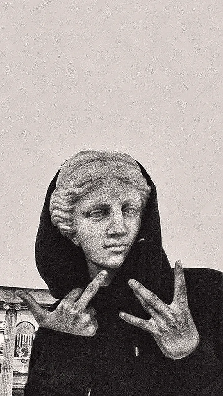 a statue in a hoodie throwing up signs